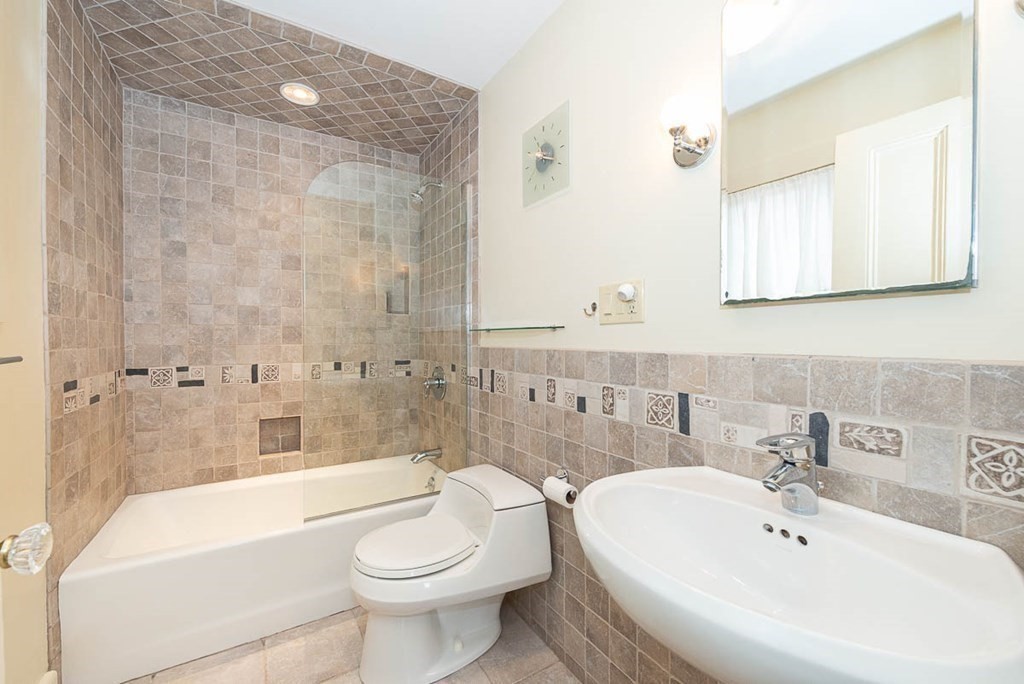 4 Jackson Court Lexington, MA 02421 - Photo 18 of 29 a bathroom with a bathtub shower sink mirror and toilet