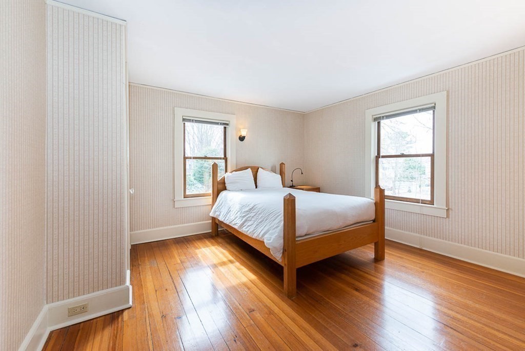 4 Jackson Court Lexington, MA 02421 - Photo 19 of 29 a bedroom with a bed and wooden floor