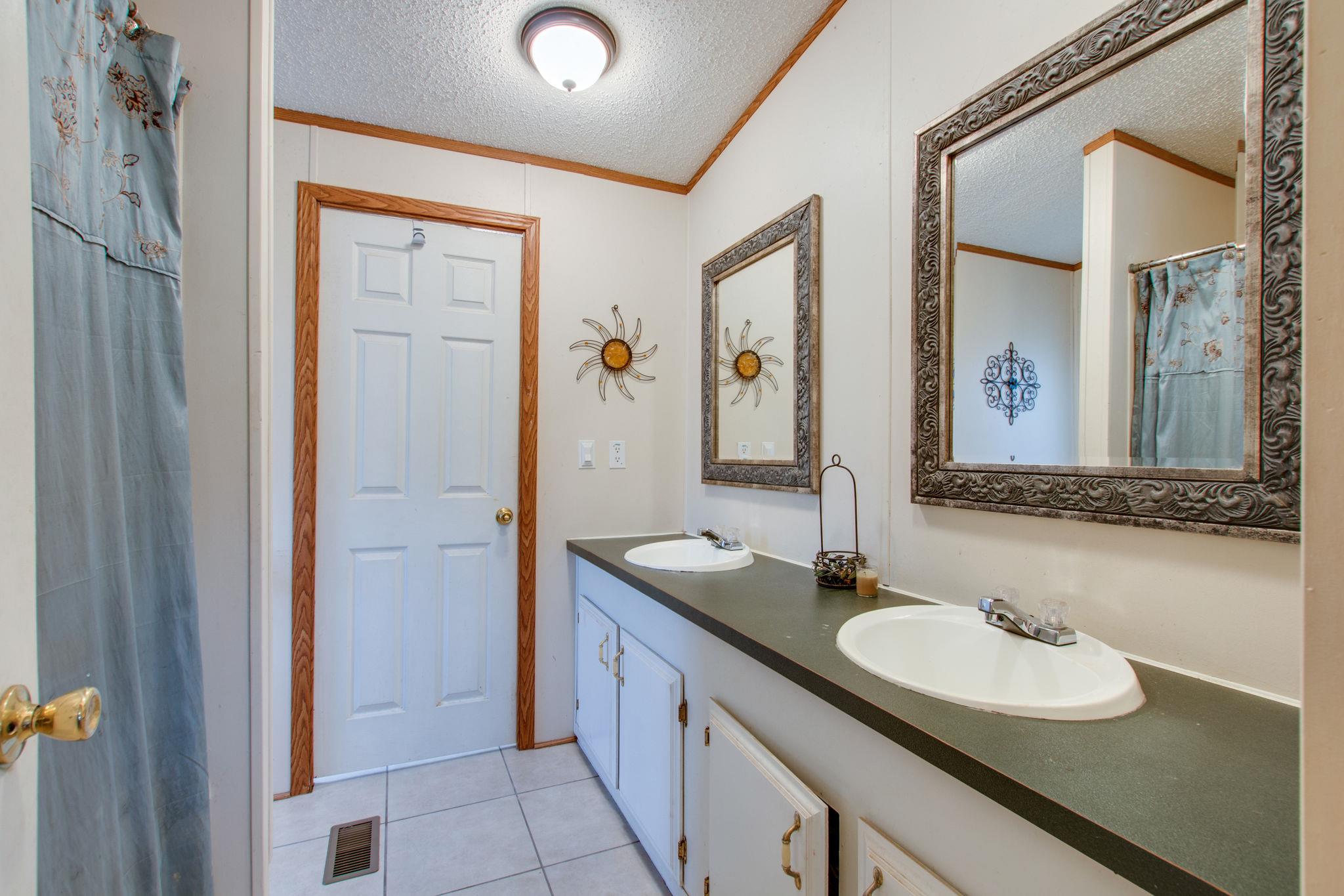3240 Beasleys Bend Road Lebanon, TN 37087 - Photo 13 of 25 a bathroom with a double vanity sink and a mirror