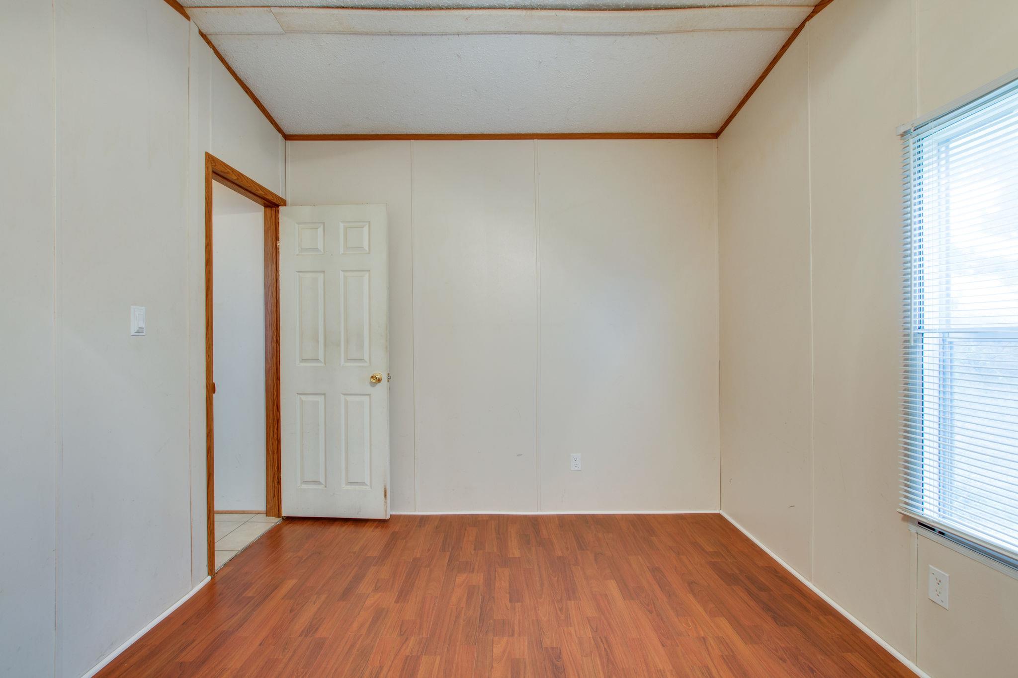 3240 Beasleys Bend Road Lebanon, TN 37087 - Photo 17 of 25 a view of an empty room with wooden floor and a window