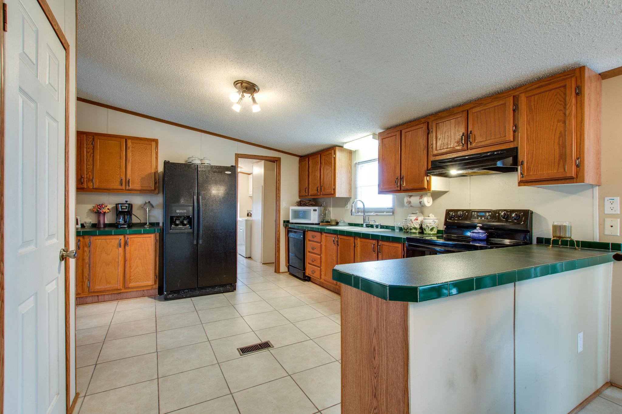 3240 Beasleys Bend Road Lebanon, TN 37087 - Photo 8 of 25 a kitchen with stainless steel appliances granite countertop a refrigerator a stove and a sink