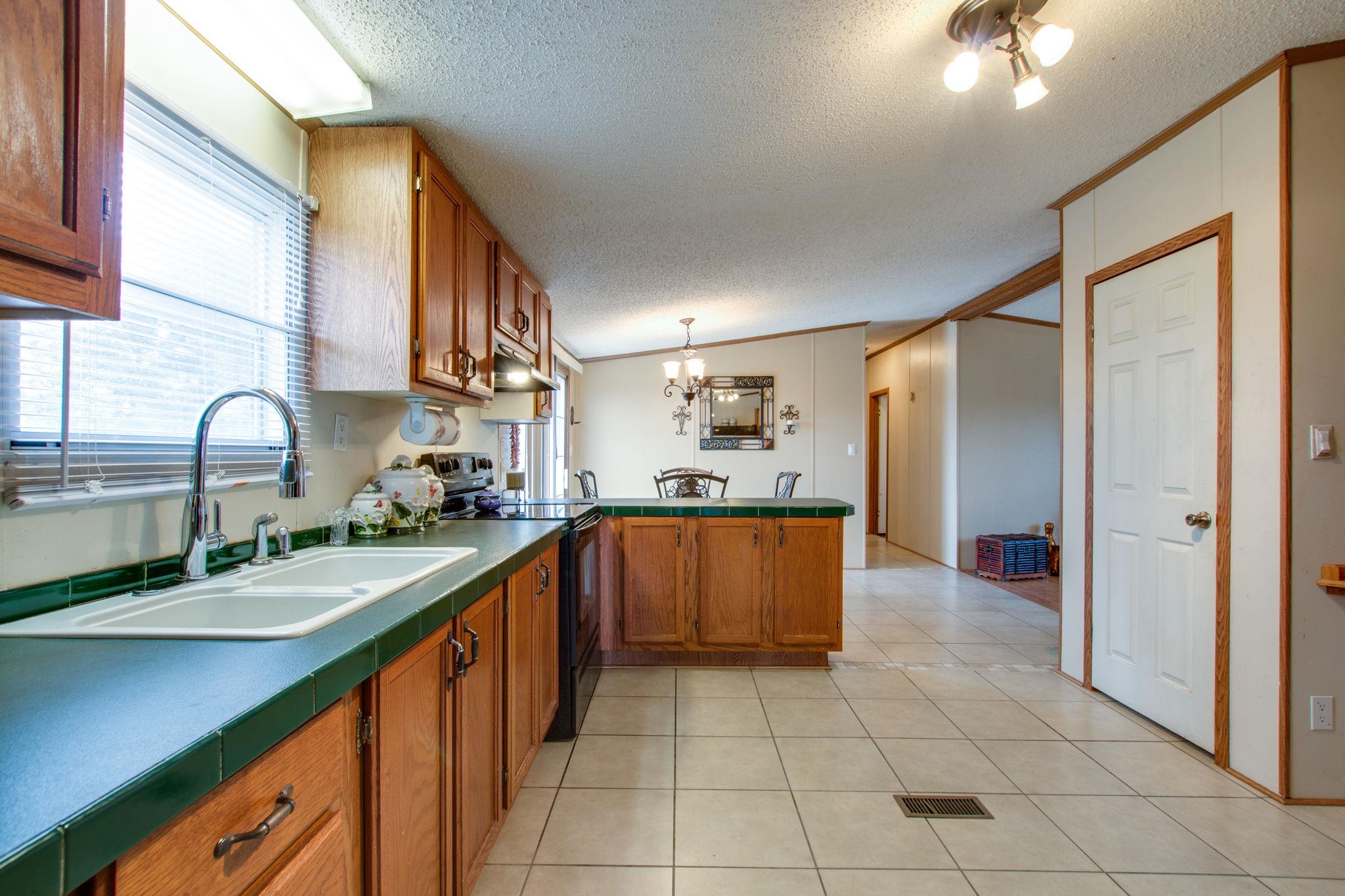 3240 Beasleys Bend Road Lebanon, TN 37087 - Photo 10 of 25 a kitchen with stainless steel appliances granite countertop a sink and cabinets