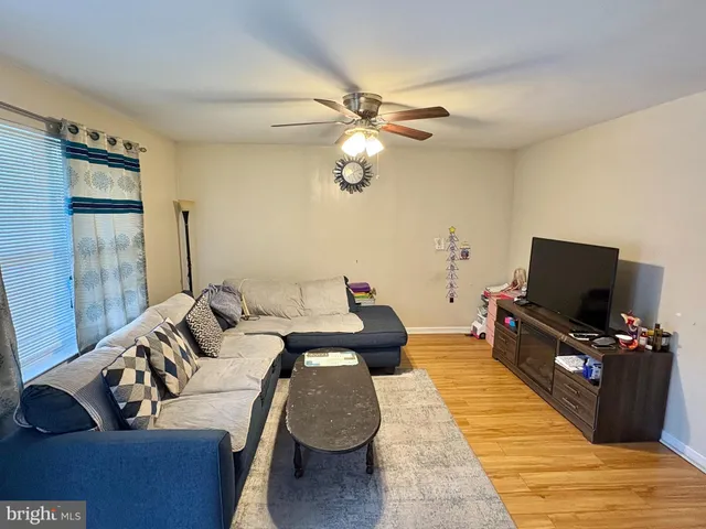 a bedroom with furniture and a flat screen tv