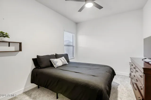 a bedroom with a bed and a night stand