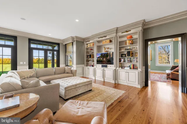 a kitchen with stainless steel appliances granite countertop a stove a sink dishwasher and a refrigerator with wooden floor