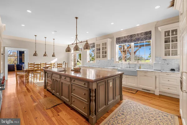 a view of a dining room with furniture a chandelier and wooden floor