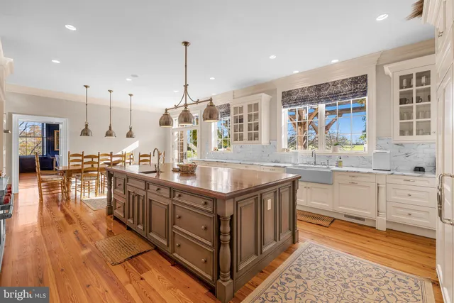a view of a dining room with furniture a chandelier and wooden floor