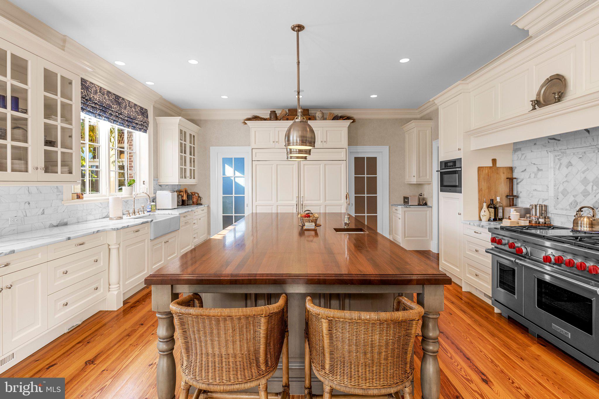 1077 Ginns Road Boyce, VA 22620 - Photo 23 of 140 a room with kitchen island a large counter top space a sink stainless steel appliances and cabinets