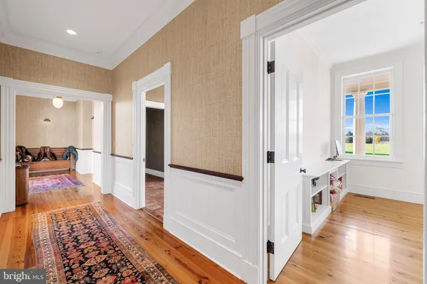 a view of staircase with white walls and wooden floor