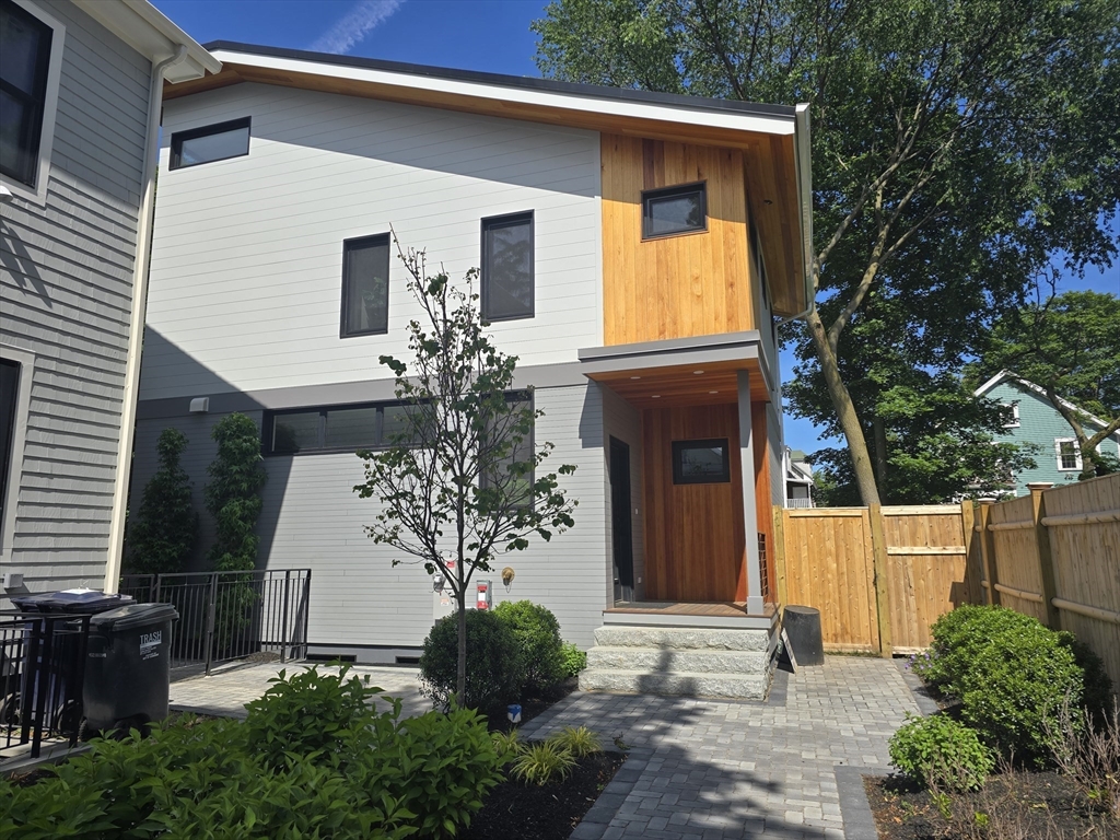 23 Reed Street, Unit 2 Cambridge, MA 02140 - Photo 2 of 37 a front view of a house with a yard