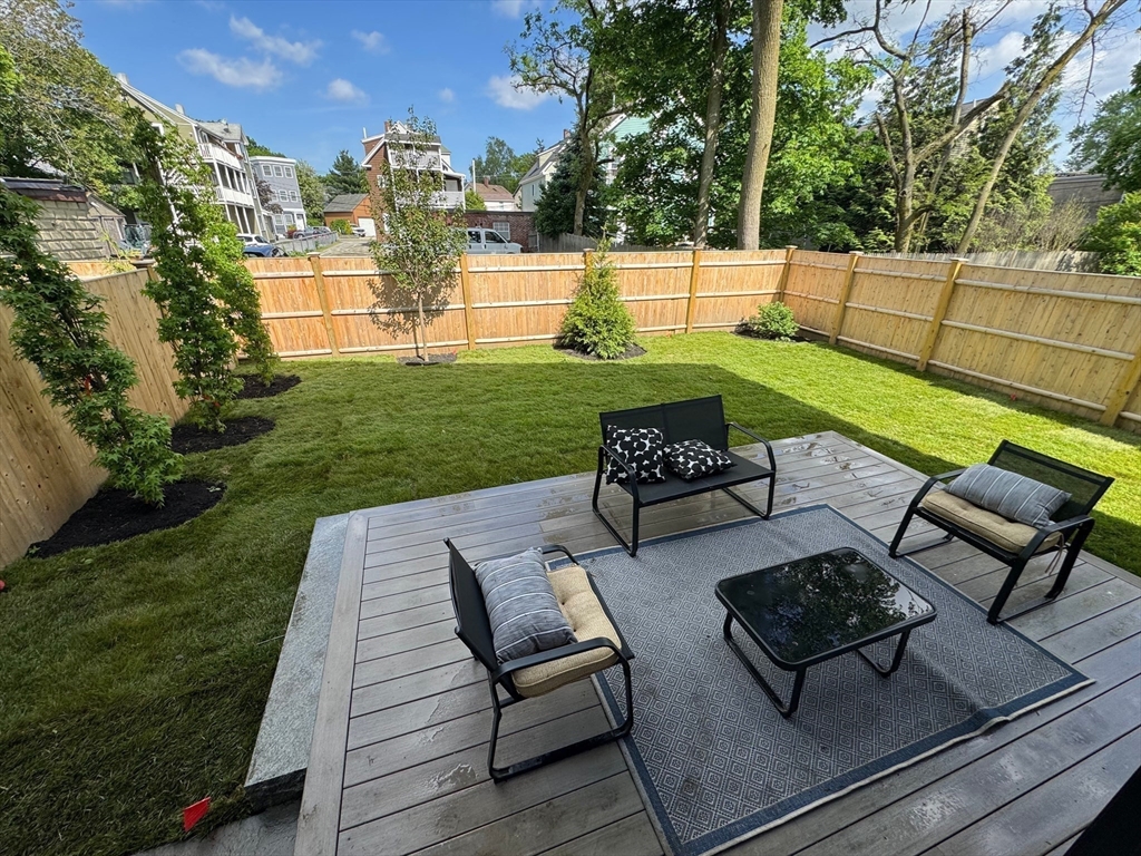 23 Reed Street, Unit 2 Cambridge, MA 02140 - Photo 3 of 37 a view of a patio with couches chairs and a fire pit