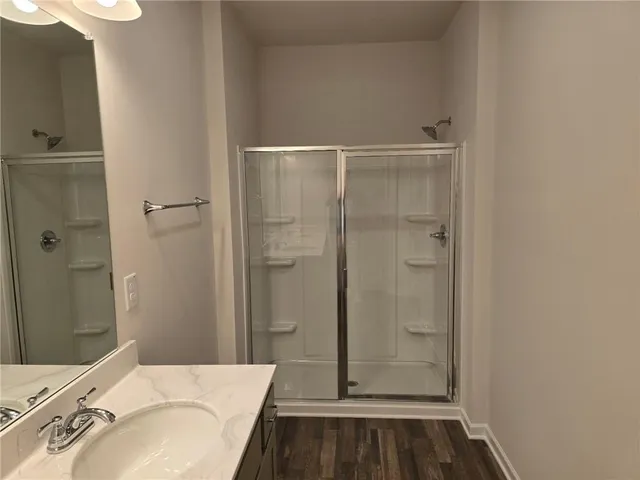 a bathroom with a granite countertop toilet and a sink