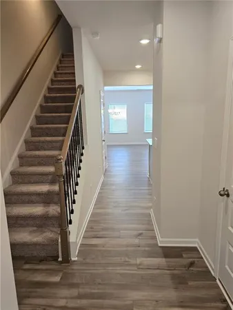 an entryway in a hallway with wooden floor