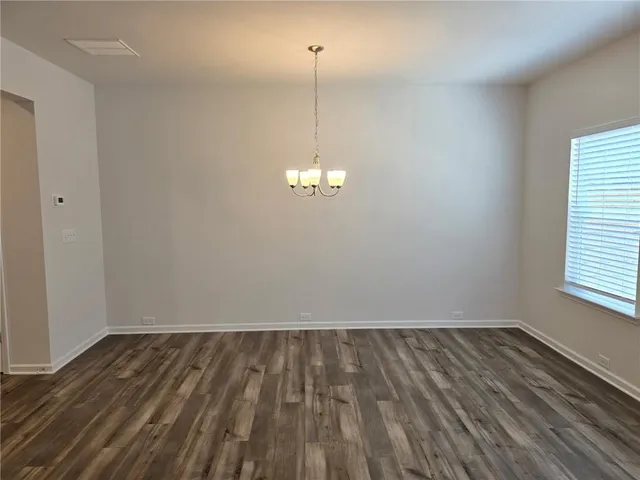 a view of a room with wooden floor and window
