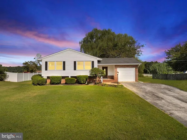 a front view of a house with swimming pool having outdoor seating
