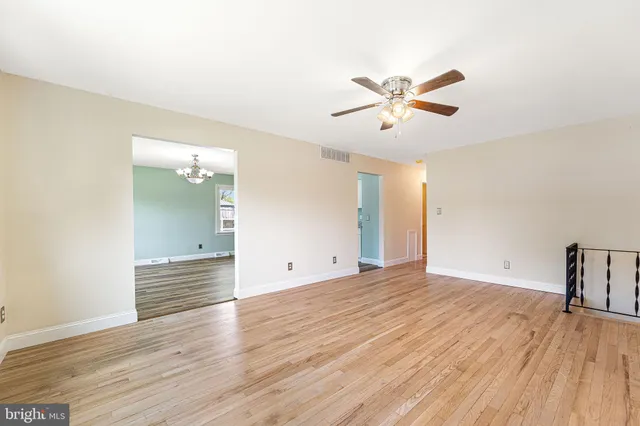 a view of an empty room and wooden floor