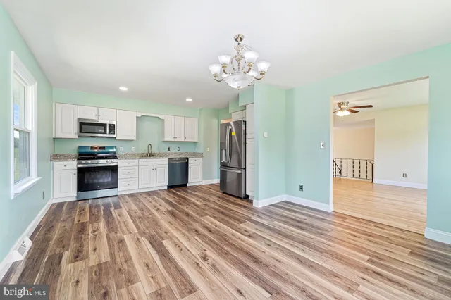a view of kitchen with granite countertop cabinets and stainless steel appliances