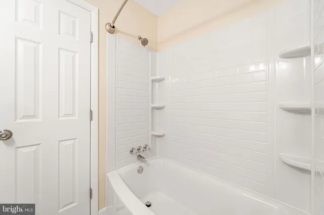 a bathroom with a bathtub and shower