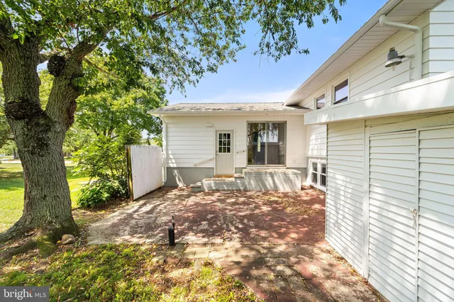 a view of a house with a tree in the background