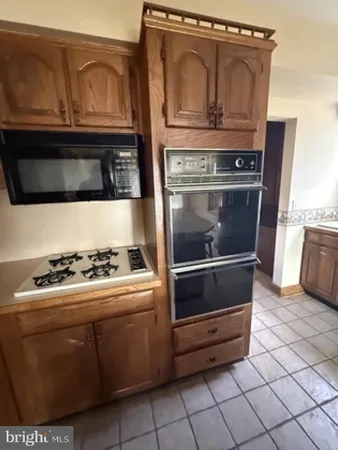 a stove top oven sitting inside of a kitchen