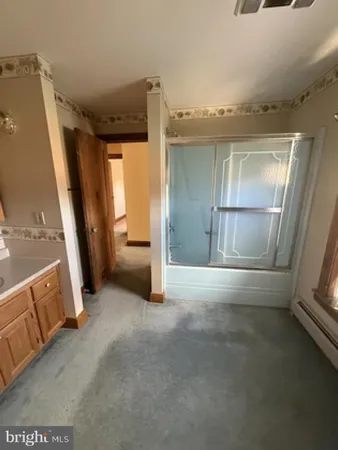 a living room with a bed furniture and a window