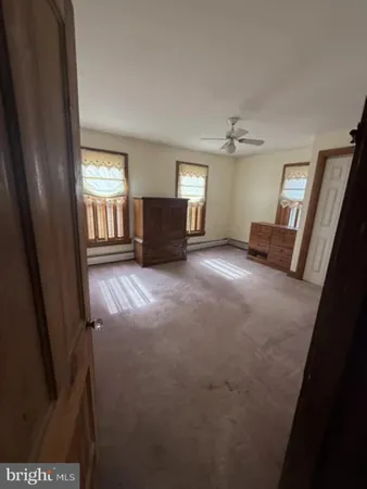a view of an empty room with a fireplace