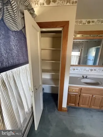 a bathroom with a window and a shower