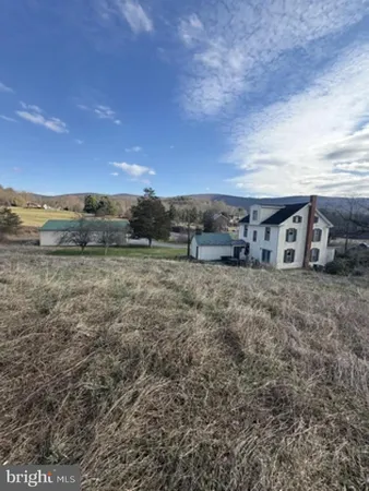 a view of house with a yard