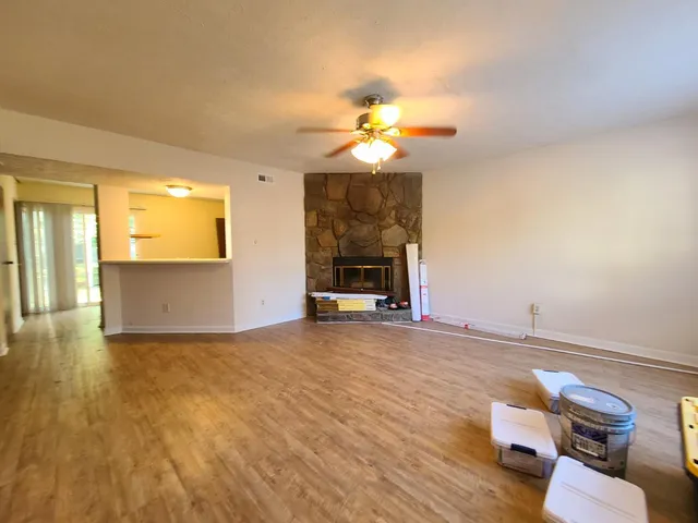 a view of a livingroom with wooden floor and a chandelier