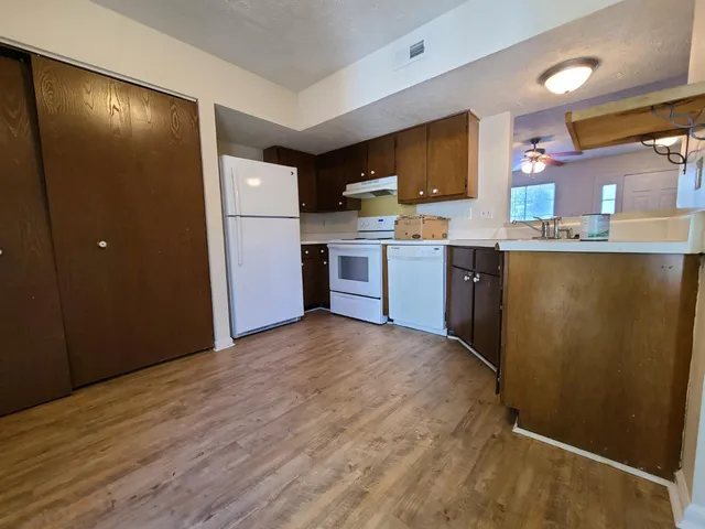 a kitchen with a refrigerator and a sink