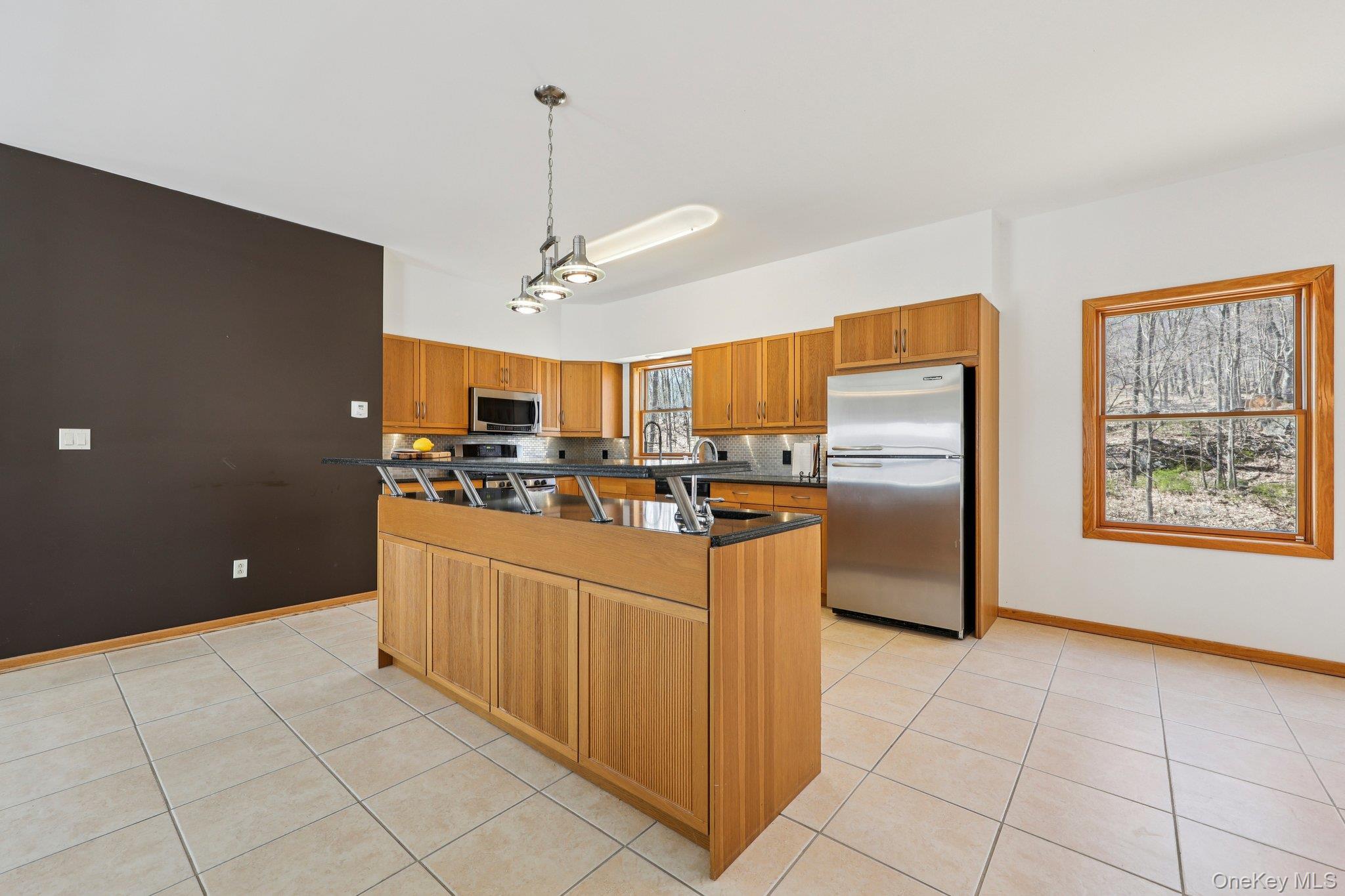 27 Krieger Road Fort Montgomery, NY 10922 - Photo 3 of 24 a kitchen with stainless steel appliances granite countertop a refrigerator and a sink
