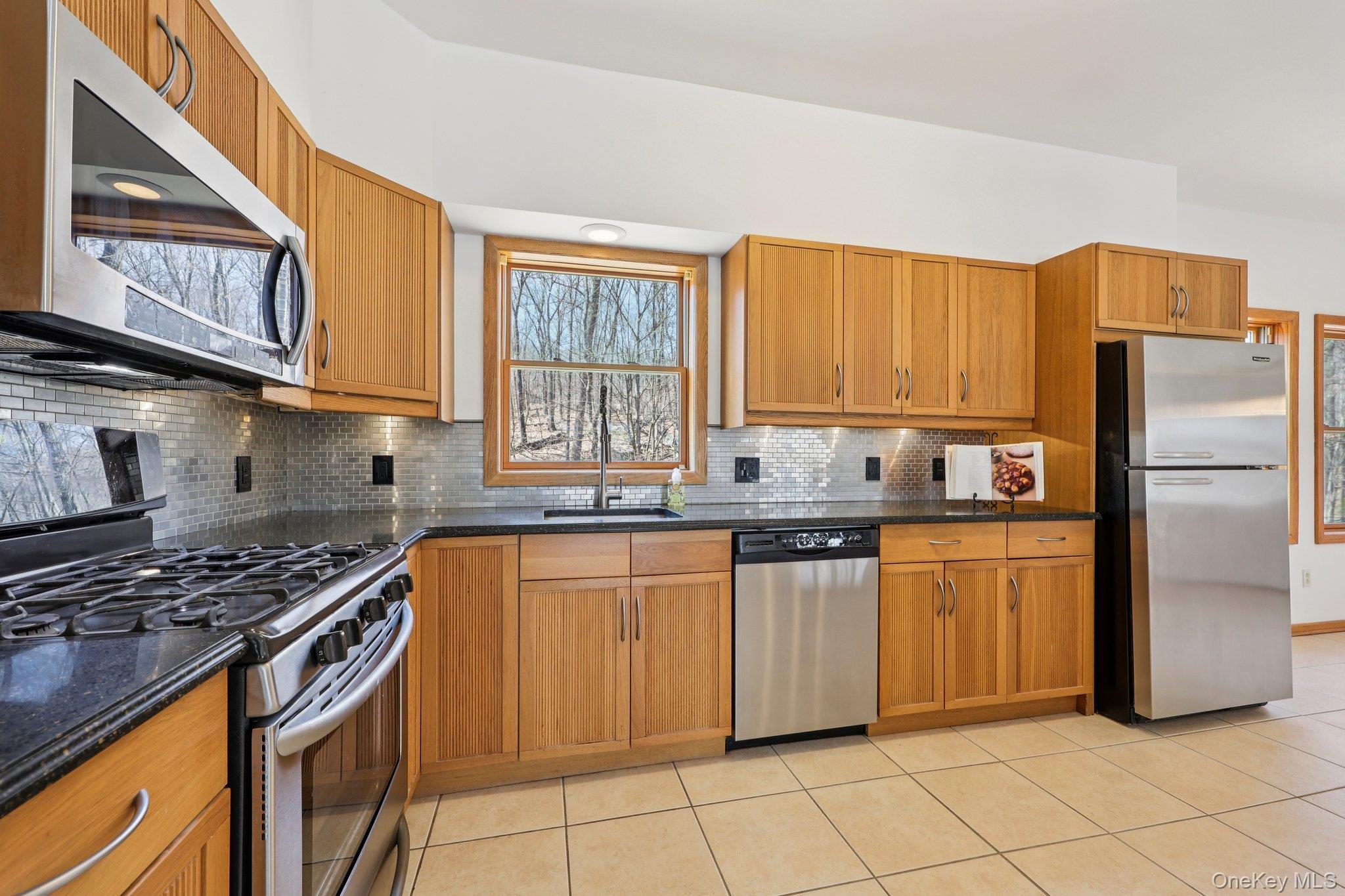 27 Krieger Road Fort Montgomery, NY 10922 - Photo 4 of 24 a kitchen with granite countertop a stove sink and refrigerator