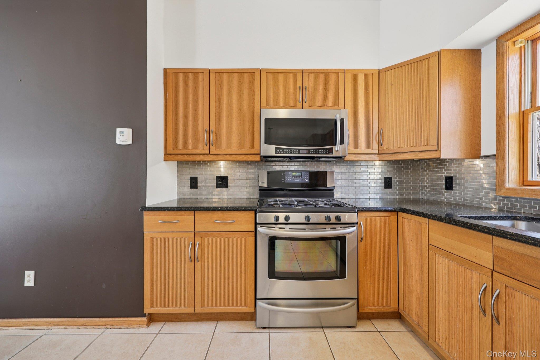 27 Krieger Road Fort Montgomery, NY 10922 - Photo 5 of 24 a kitchen with stainless steel appliances granite countertop a stove microwave and sink