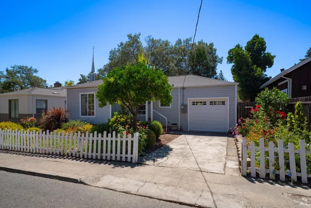 a front view of a house with a garden