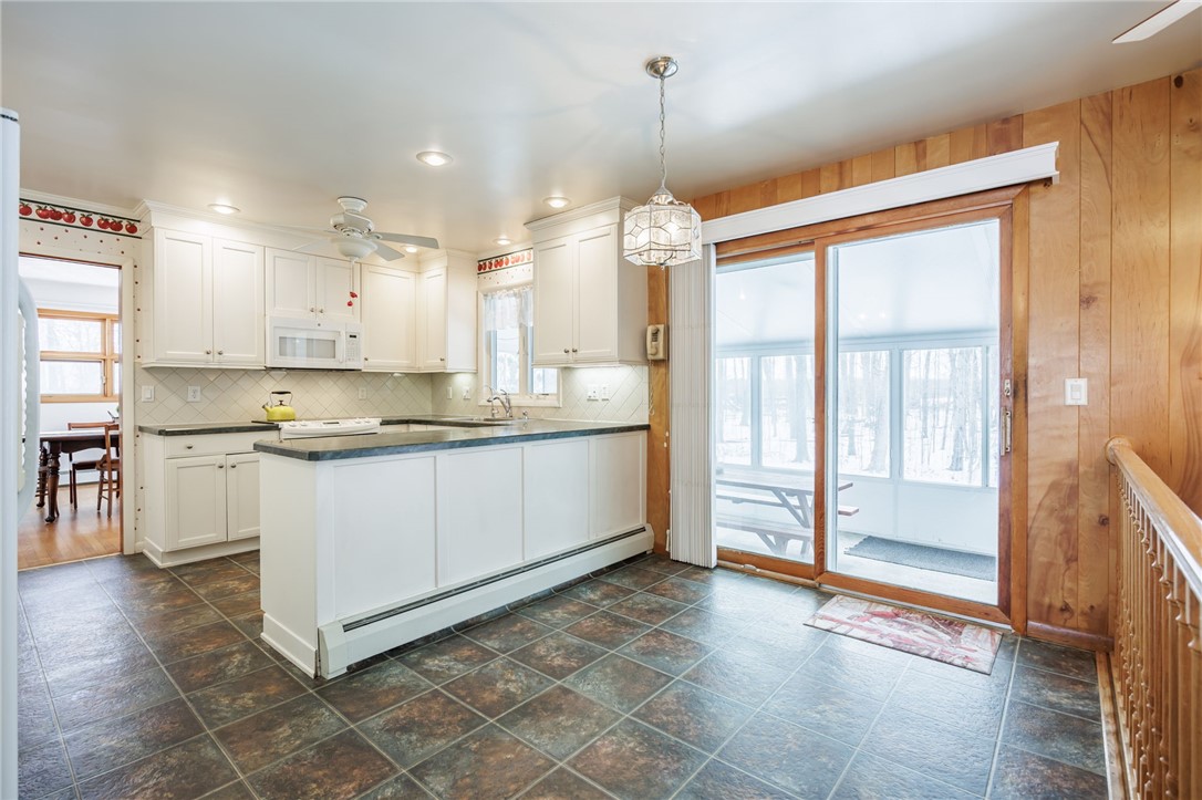 2327 Gorham Road Seneca, NY 14561 - Photo 17 of 48 Kitchen opens to the three season room