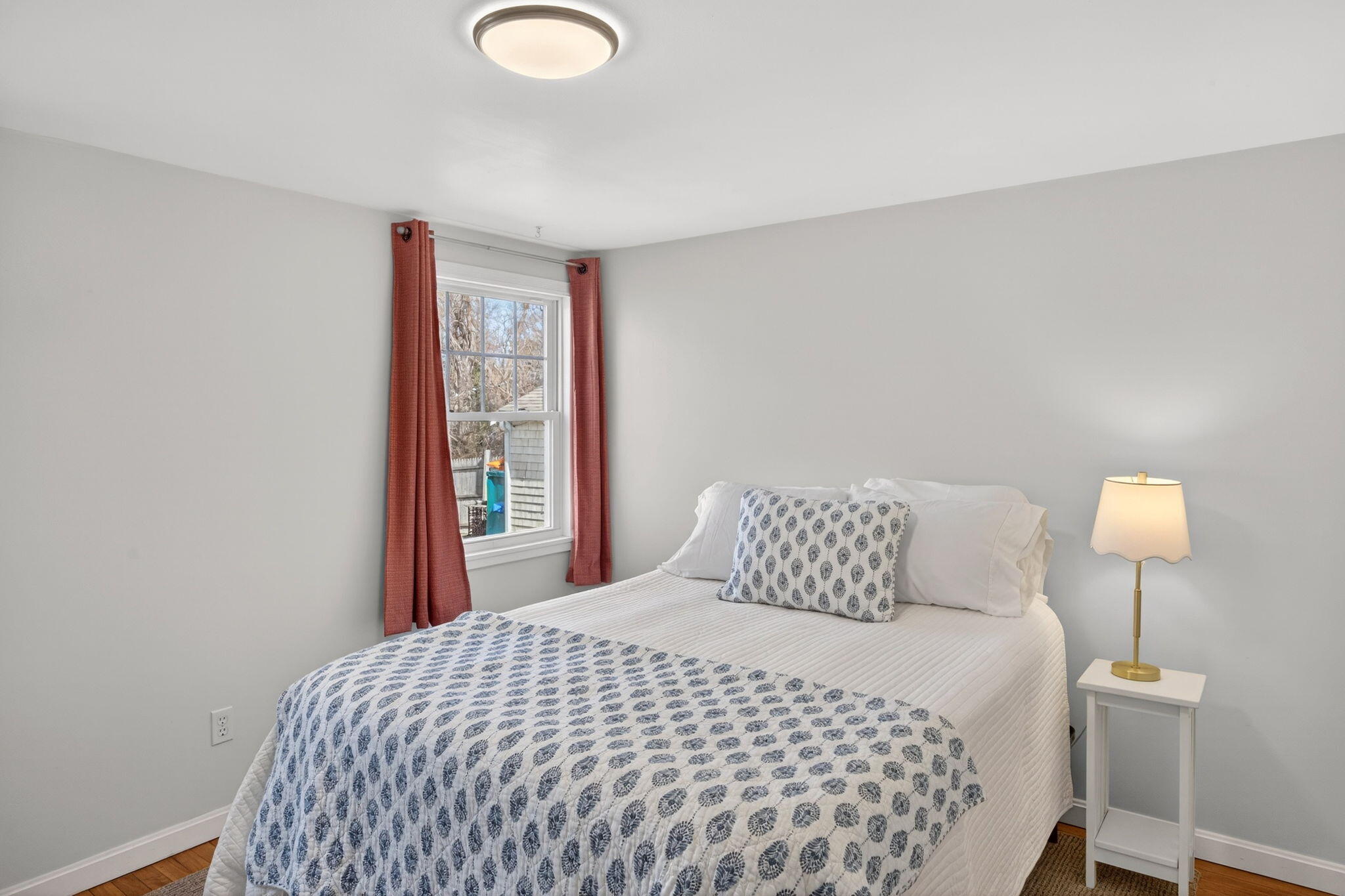 3 Januit Street Sandwich, MA 02563 - Photo 15 of 32 a bedroom with a bed and a lamp
