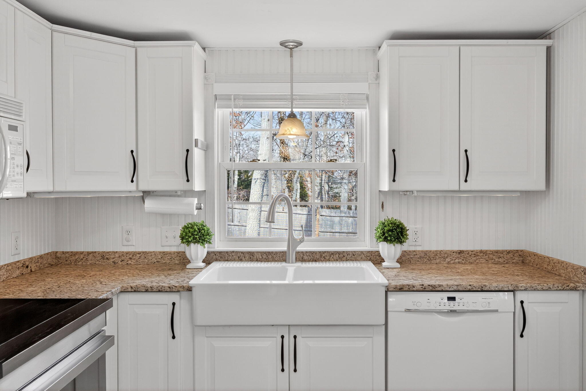 3 Januit Street Sandwich, MA 02563 - Photo 9 of 32 a kitchen with granite countertop a sink window and white cabinets