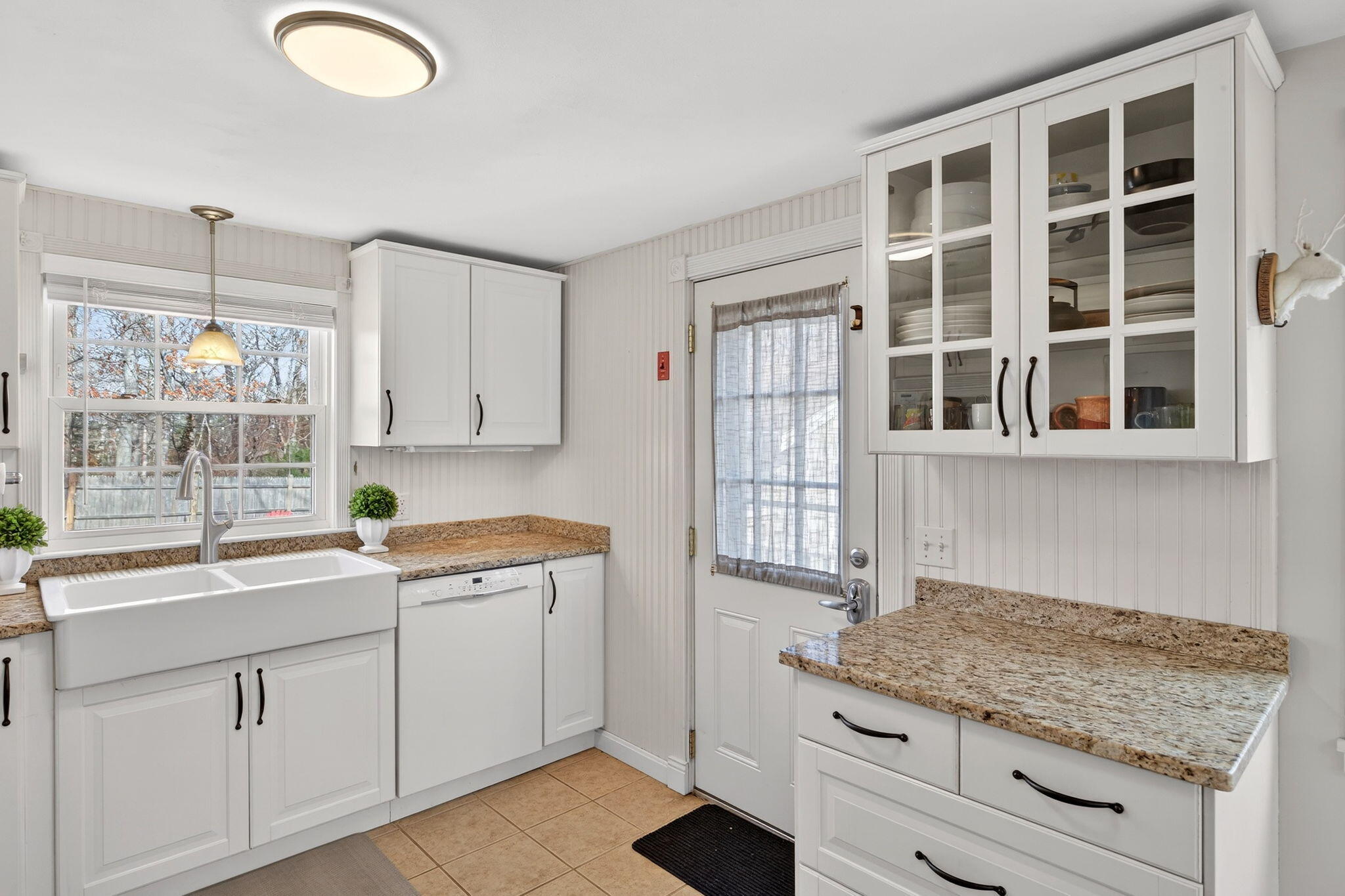 3 Januit Street Sandwich, MA 02563 - Photo 10 of 32 a kitchen with a sink window and cabinets