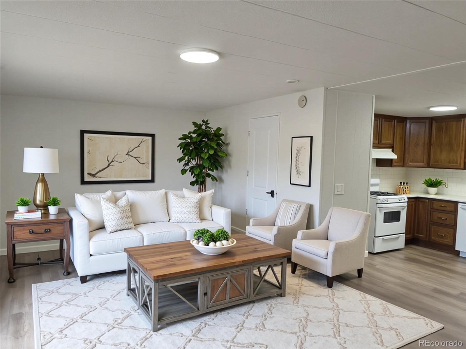 7169 Henry Street Fort Lupton, CO 80621 - Photo 14 of 14 a living room with furniture and wooden floor