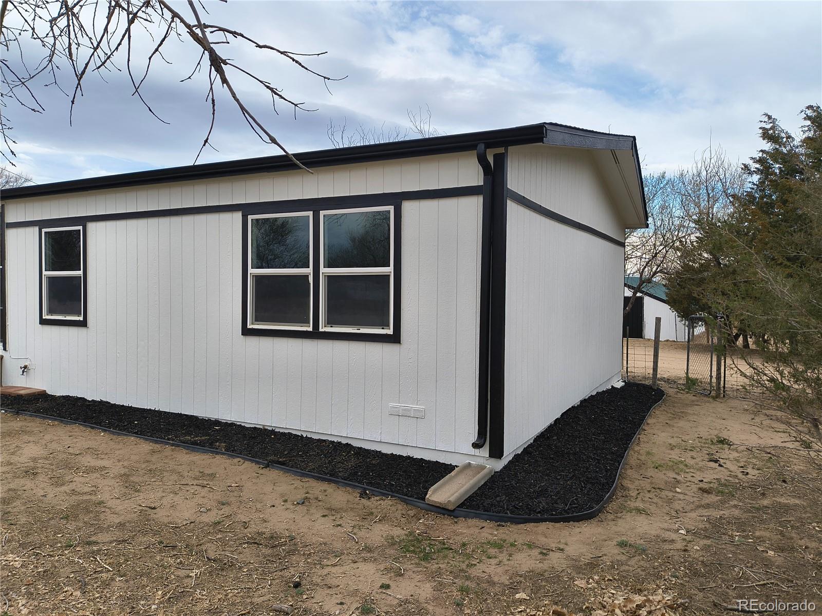 7169 Henry Street Fort Lupton, CO 80621 - Photo 2 of 14 a backyard of a house