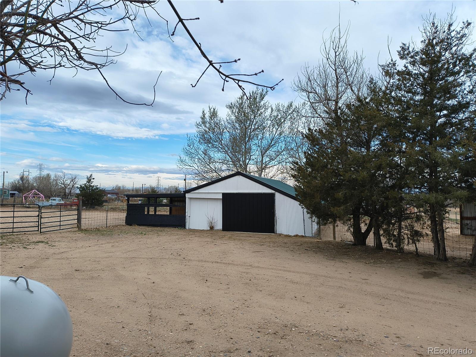 7169 Henry Street Fort Lupton, CO 80621 - Photo 3 of 14 a view of a house with a yard