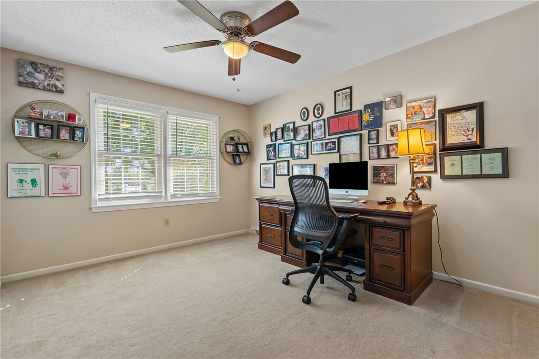 3513 Hopewell Road Anderson, SC 29621 - Photo 3 of 50 A well-lit home office features carpeted floors and a prominent ceiling fan.