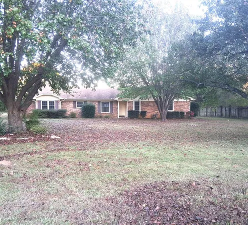a view of a house with yard and sitting area