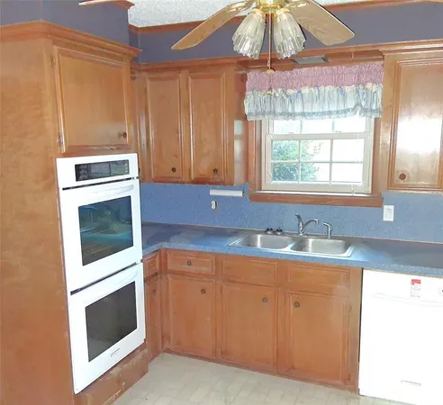 a kitchen with a sink stove and microwave