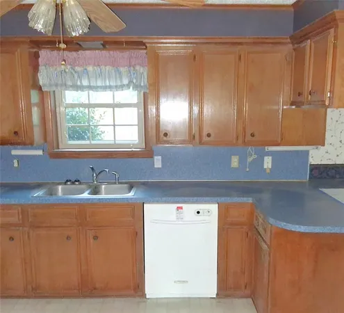 a kitchen with a sink a cabinets and window
