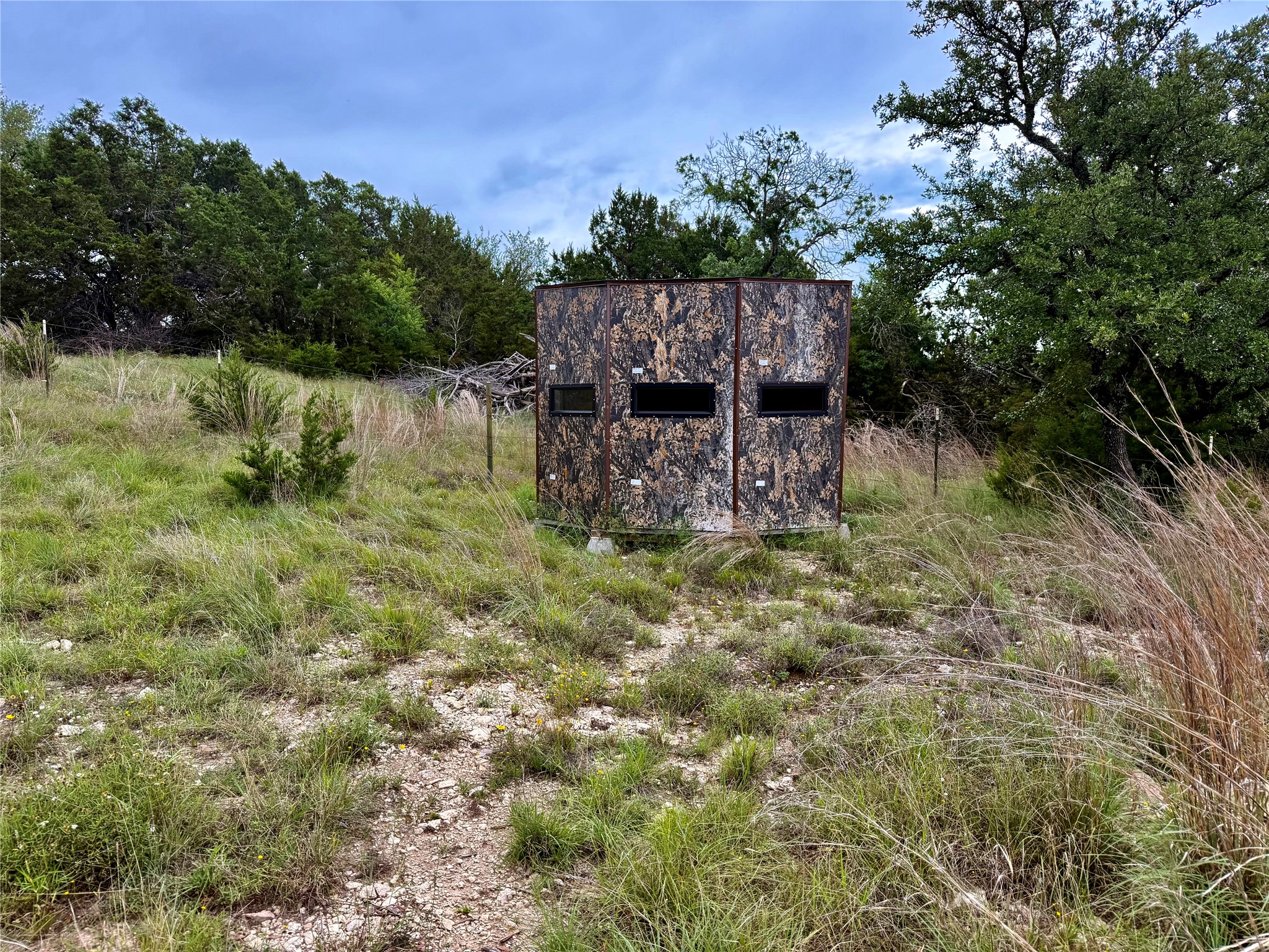 2017 County Road 222 Kempner, TX 76539 - Photo 10 of 16 Camouflage-patterned blind with multiple window openings set on a grassy, sloped terrain