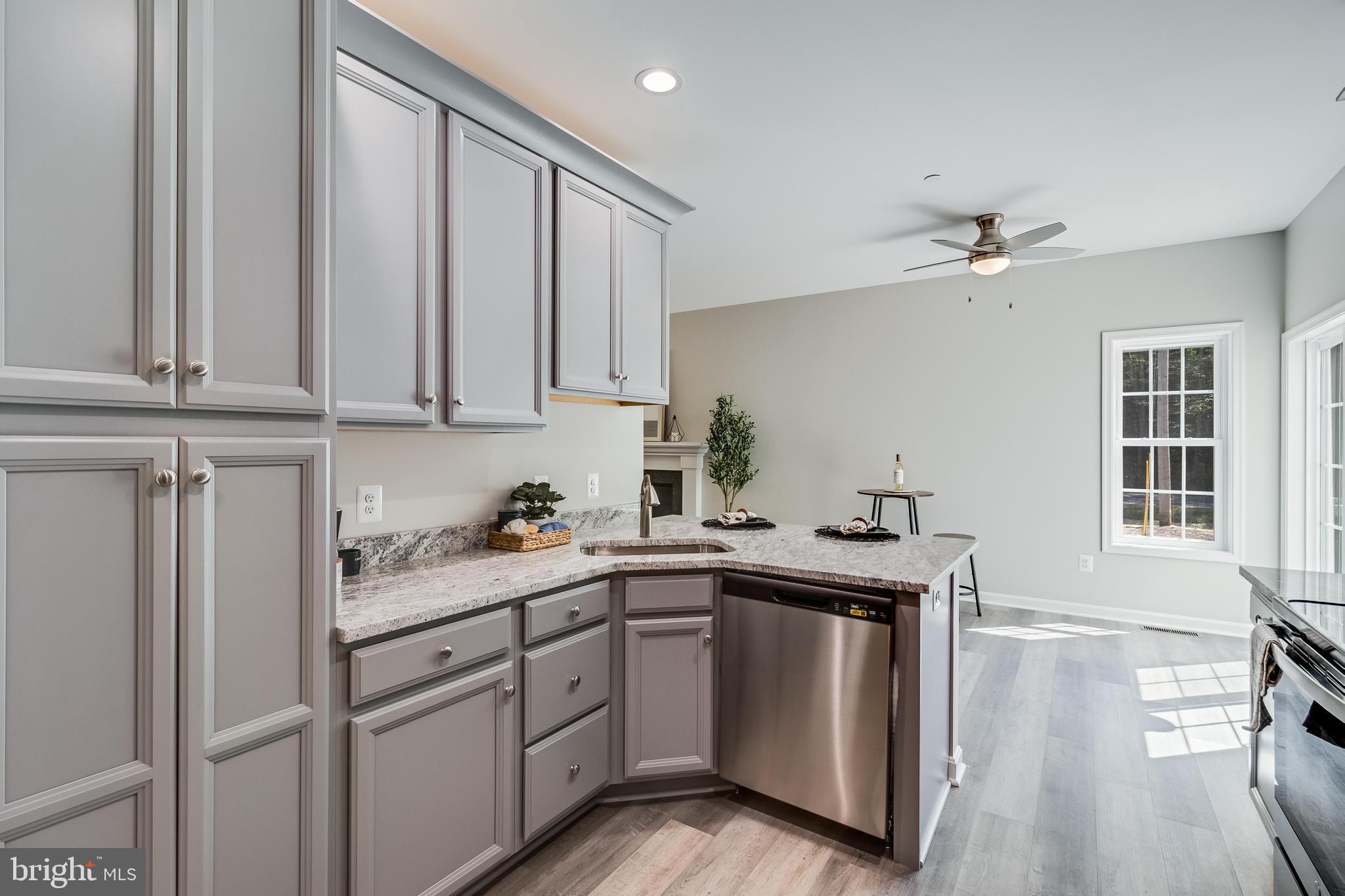 21183 Abell Road Avenue, MD 20609 - Photo 29 of 36 a kitchen with stainless steel appliances granite countertop a sink a stove and cabinets