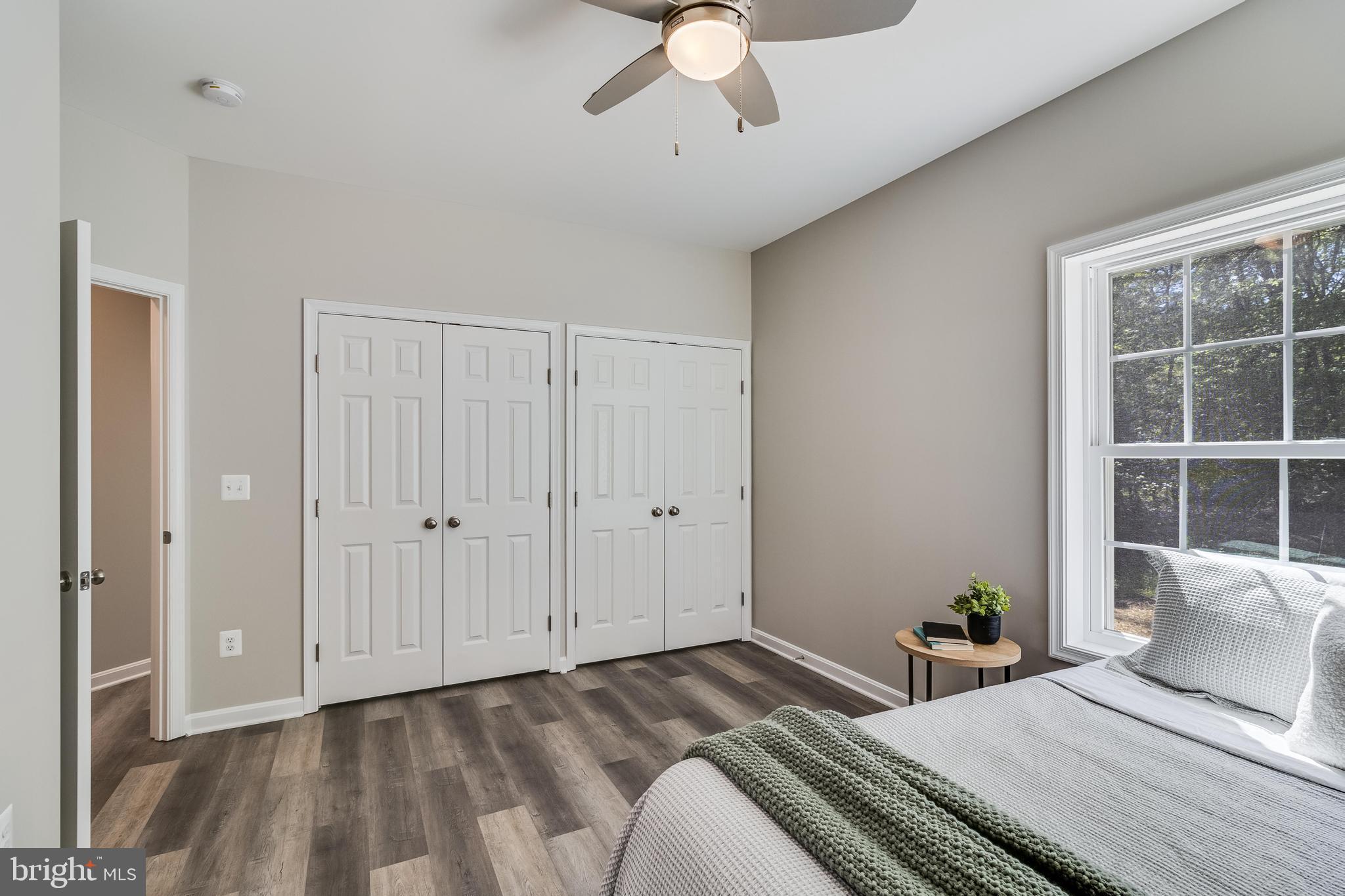21183 Abell Road Avenue, MD 20609 - Photo 32 of 36 a bedroom with a large bed and a window