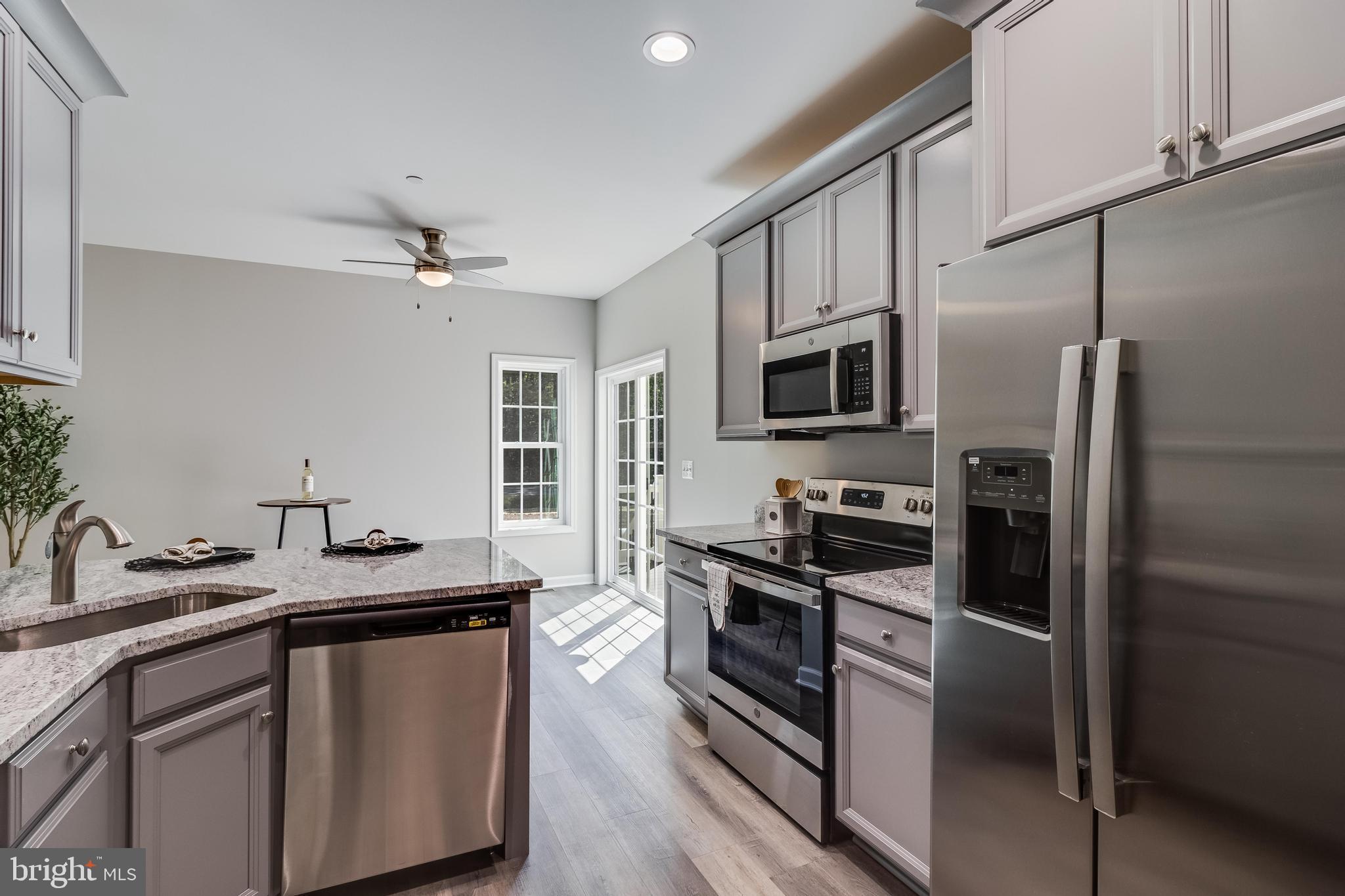 21183 Abell Road Avenue, MD 20609 - Photo 6 of 36 a kitchen with a sink stainless steel appliances and white cabinets