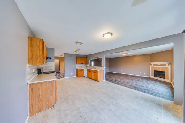 a view of a kitchen with a sink and a refrigerator